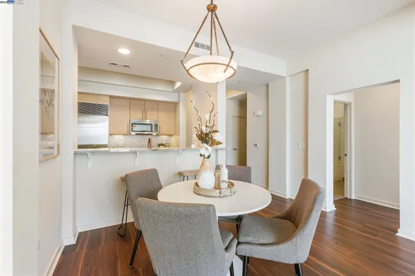 a view of a dining room with furniture and wooden floor