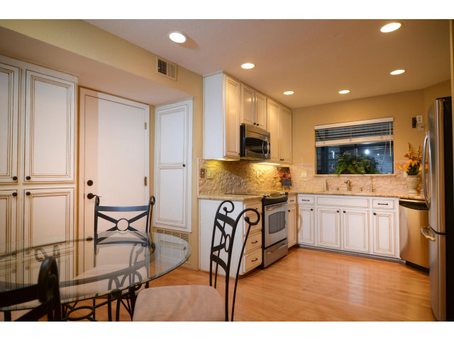 133 Redding Road, Unit B Campbell, CA 95008 - Photo 5 of 12 a kitchen with granite countertop a stove top oven microwave and cabinets