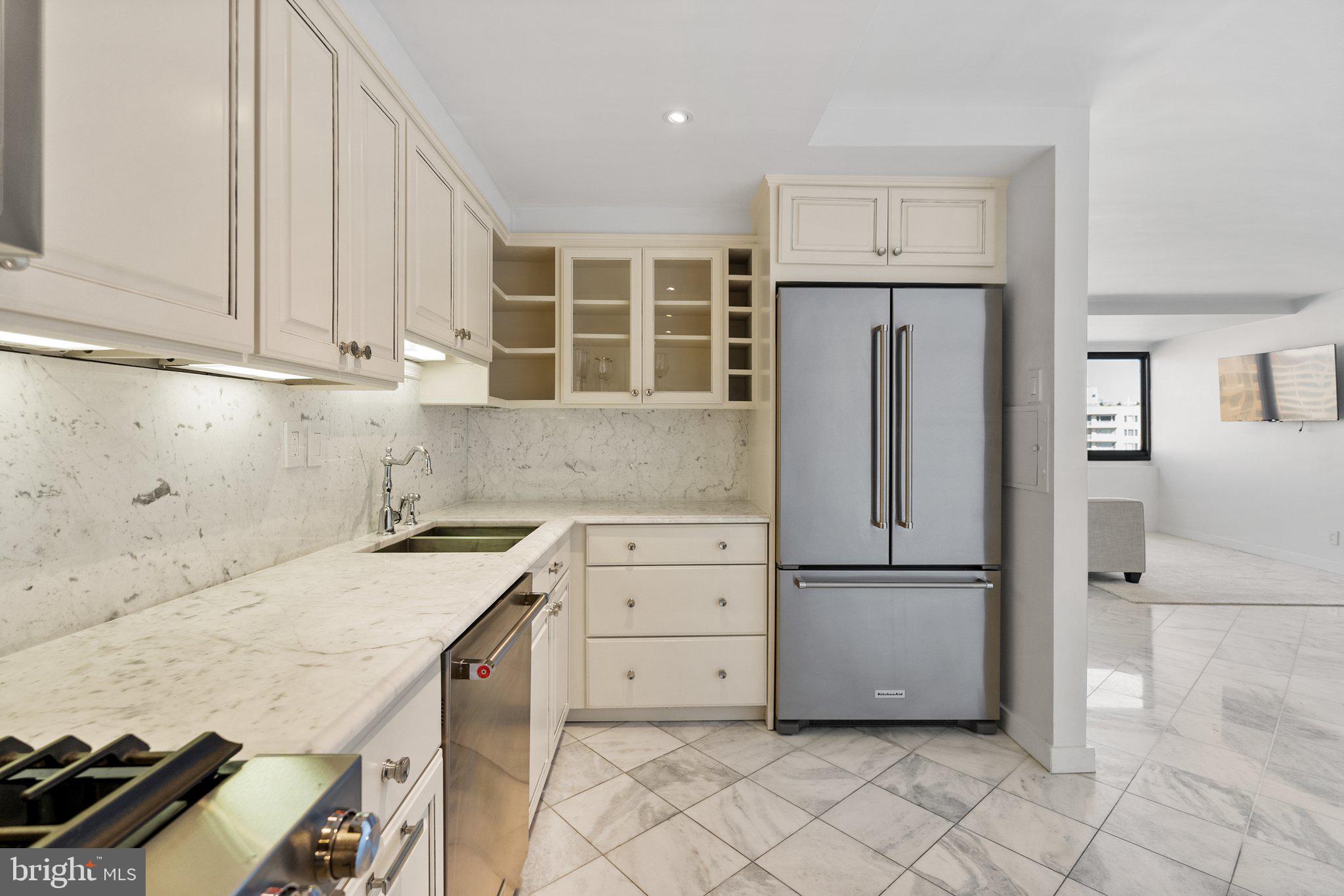 2500 Virginia Avenue Northwest, Unit 1005S Washington, DC 20037 - Photo 11 of 42 a kitchen with a refrigerator sink and cabinets