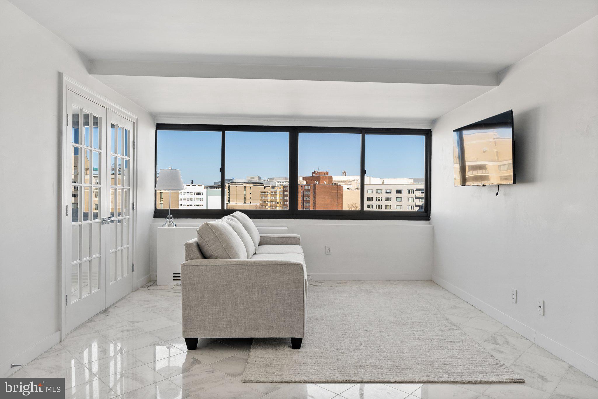 2500 Virginia Avenue Northwest, Unit 1005S Washington, DC 20037 - Photo 3 of 42 a living room with furniture and windows