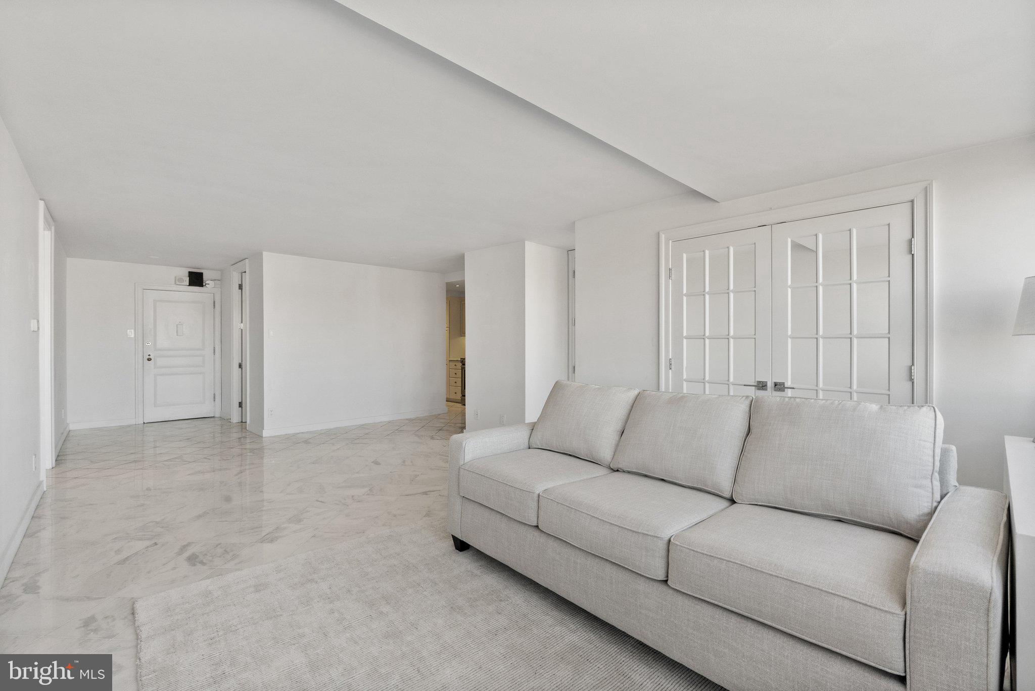 2500 Virginia Avenue Northwest, Unit 1005S Washington, DC 20037 - Photo 4 of 42 a living room with furniture and white walls
