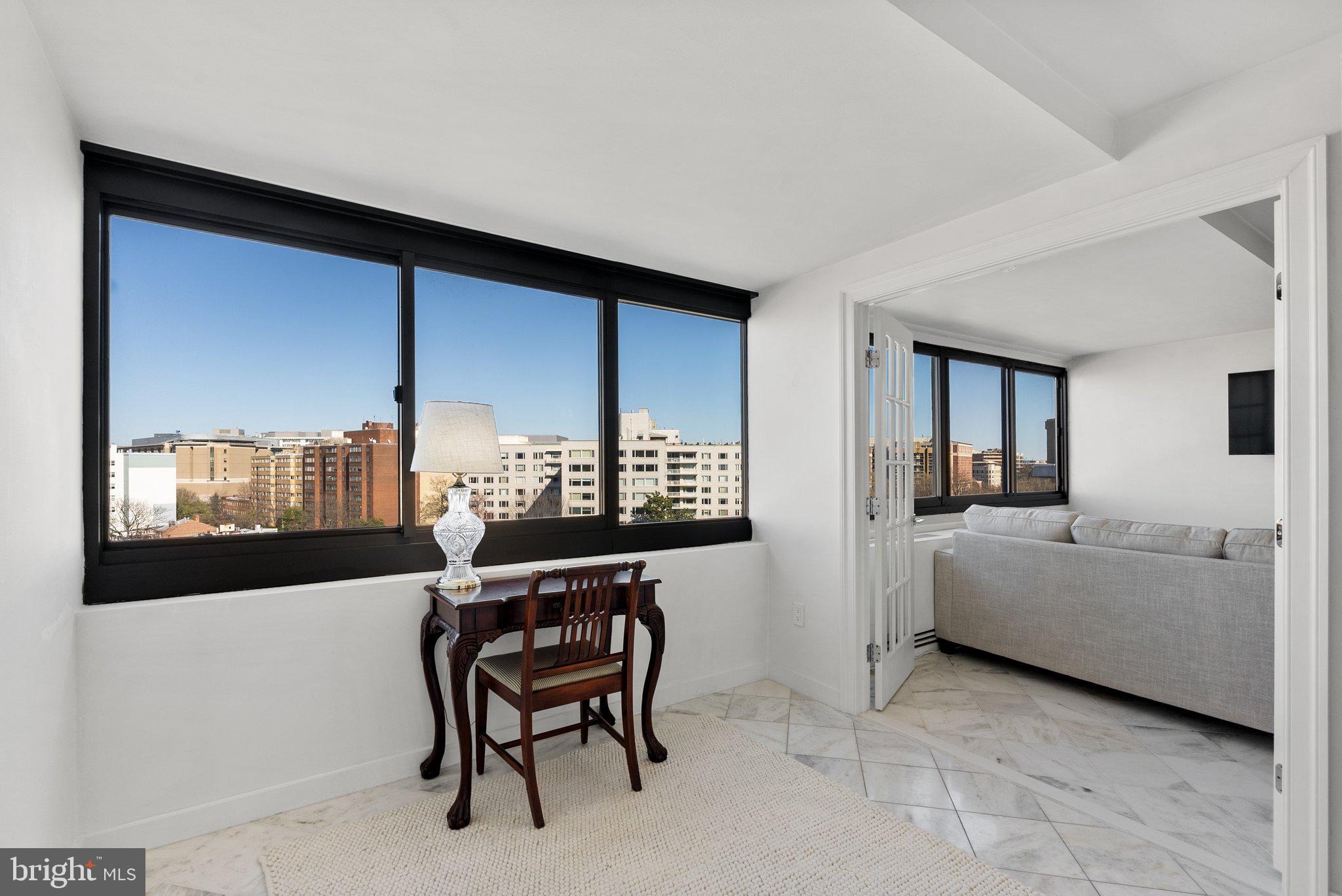2500 Virginia Avenue Northwest, Unit 1005S Washington, DC 20037 - Photo 6 of 42 a living room with furniture and a large window
