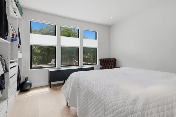 a large white bed in a white bedroom
