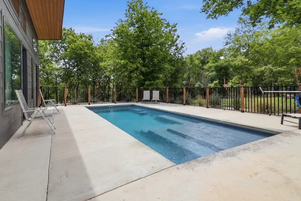 an aerial view of a house with pool