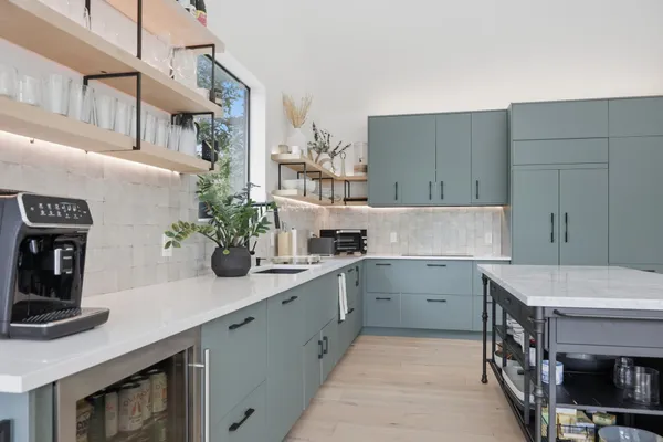 a kitchen with a table chairs stove and cabinets