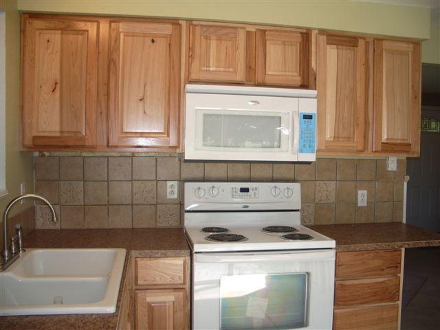930 North Granger Road Granger, WA 98932 - Photo 12 of 19 a kitchen with granite countertop wood cabinets and white appliances