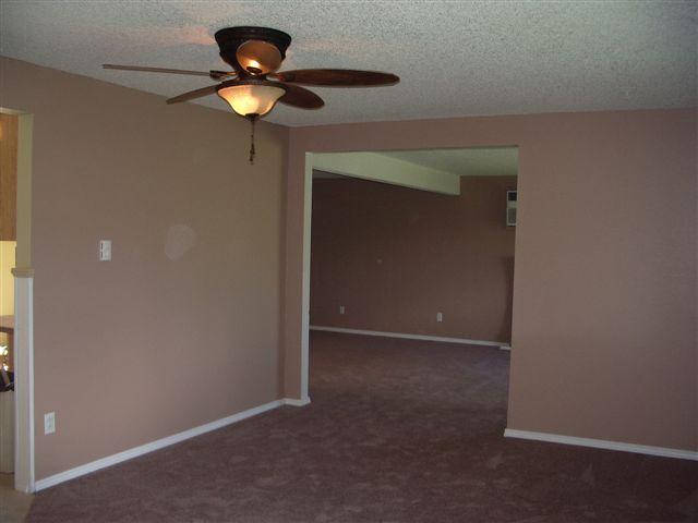 930 North Granger Road Granger, WA 98932 - Photo 16 of 19 a view of an empty room with a ceiling fan and window