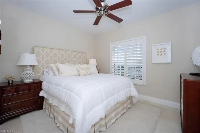 a bedroom with a bed and a night stand