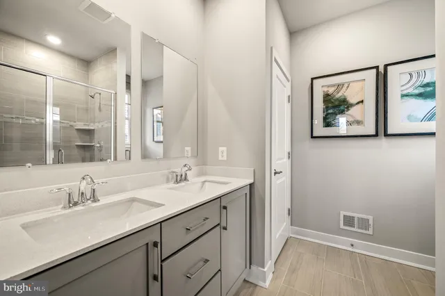 a bathroom with a double vanity sink and a mirror