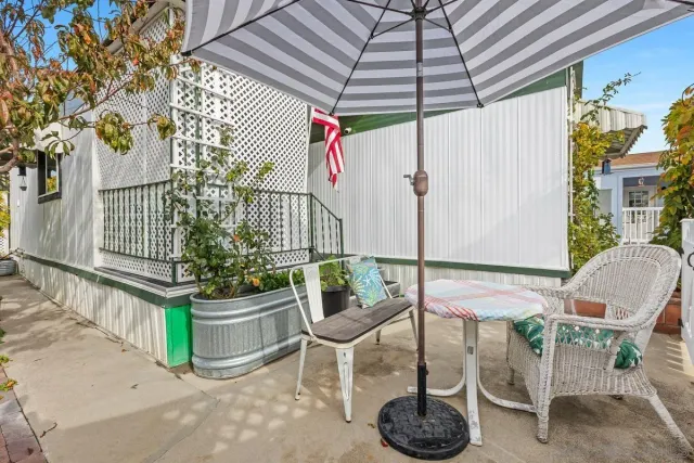 a view of a chair and table in backyard