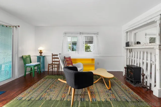 a living room with furniture a dining table and a potted plant