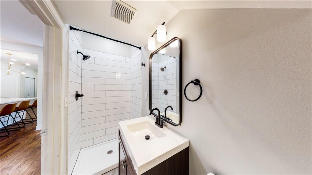 69 Atlanta Avenue Southwest Atlanta, GA 30315 - Photo 25 of 29 a bathroom with a shower sink and mirror