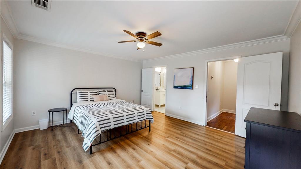 69 Atlanta Avenue Southwest Atlanta, GA 30315 - Photo 8 of 29 a bedroom with a bed and wooden floor