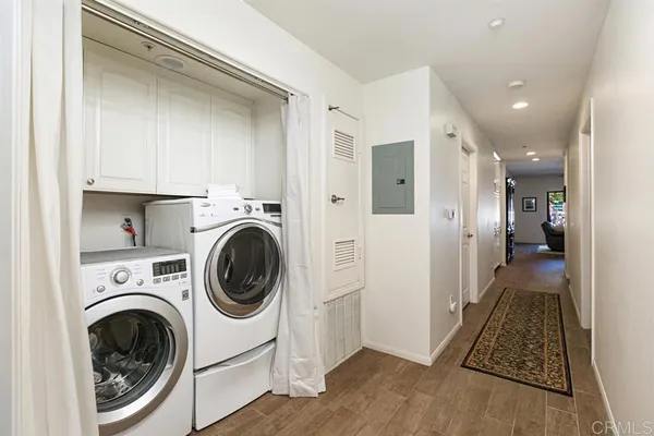 a living room with patio furniture and a potted plant