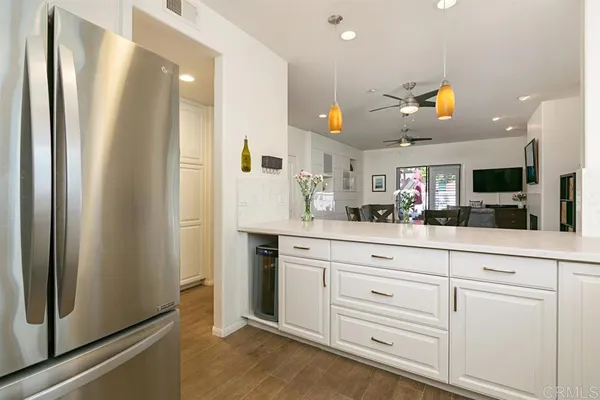 a kitchen with granite countertop white cabinets stainless steel appliances and a sink
