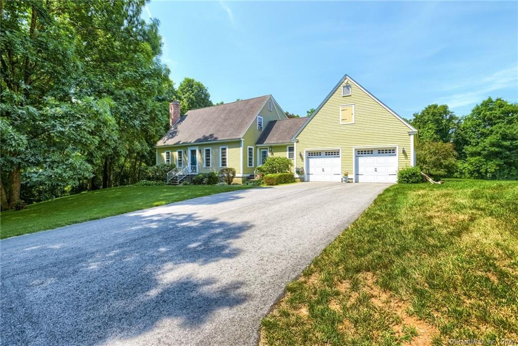 sloping driveway to 3 Bedroom, 2 bath and large 2 car garage