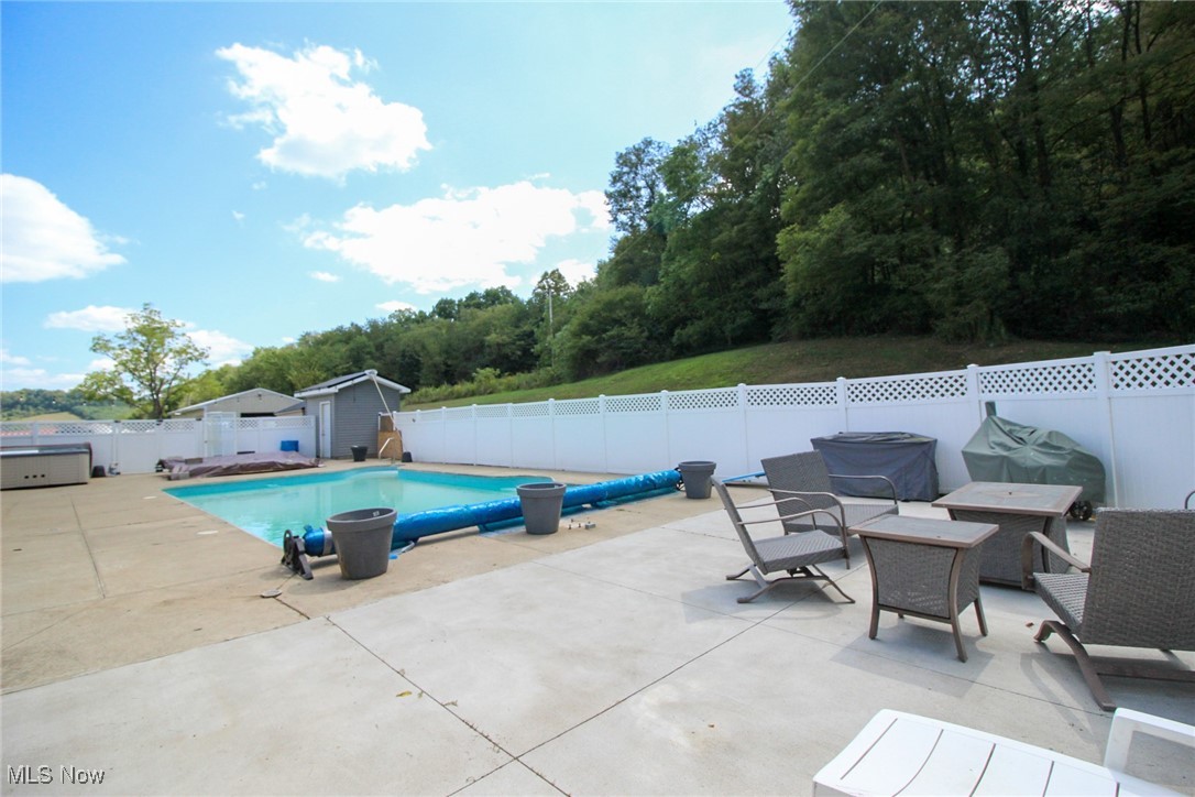 1798 Campbell Road Southwest New Philadelphia, OH 44663 - Photo 41 of 50 View of pool with an outdoor structure and a patio