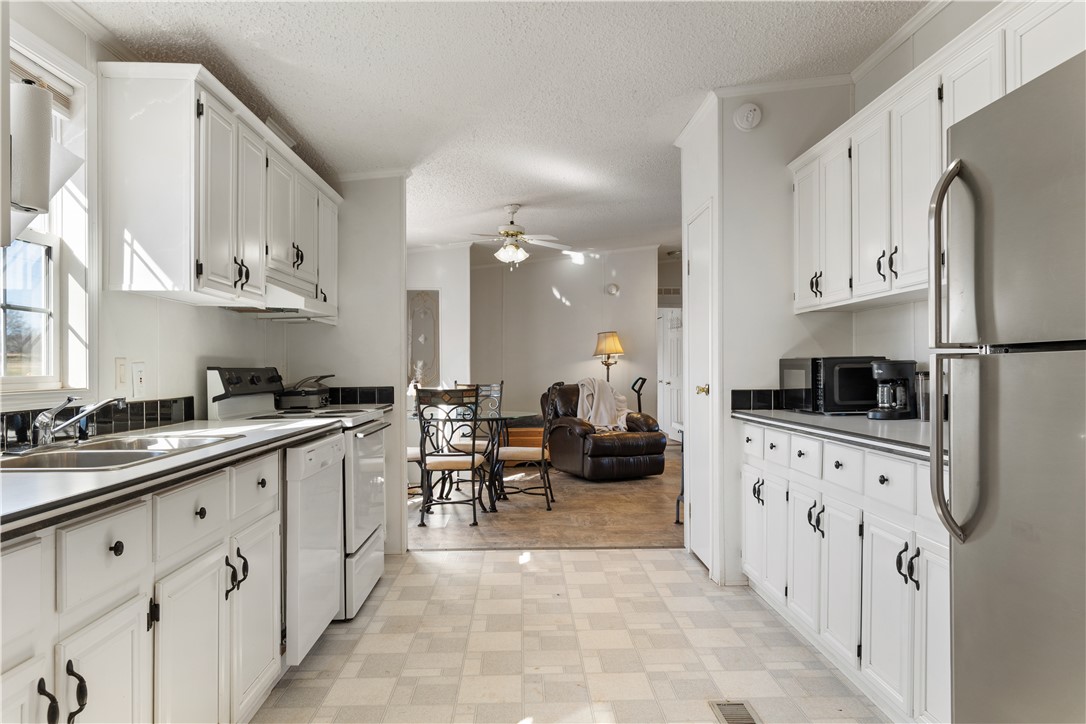 811 Pine Grove Road Seneca, SC 29678 - Photo 6 of 20 This spacious kitchen offers ample cabinet storage and opens directly into the living area.
