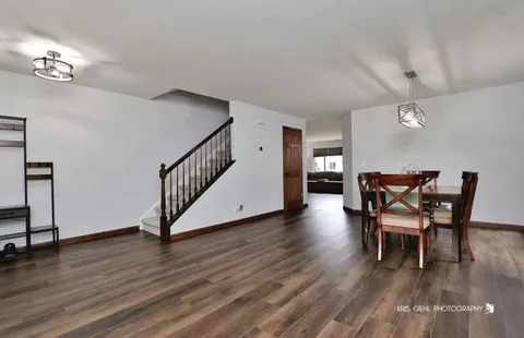 a dining room with furniture and wooden floor