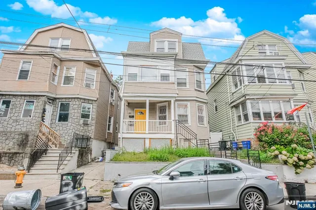 a front view of a house with parking space