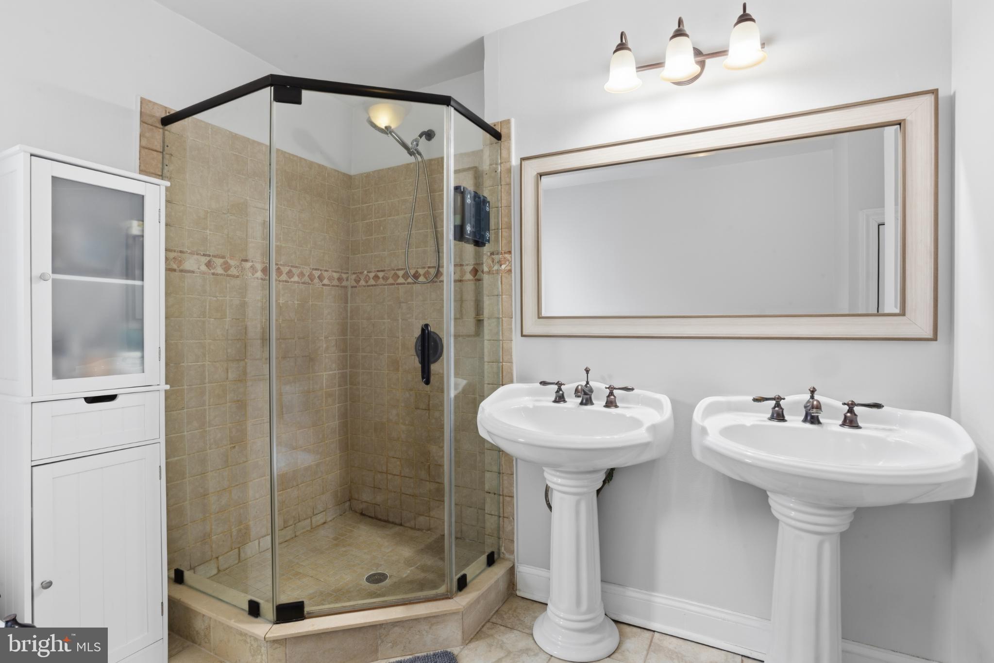 902 South 8th Street Philadelphia, PA 19147 - Photo 30 of 33 a bathroom with a sink mirror and shower