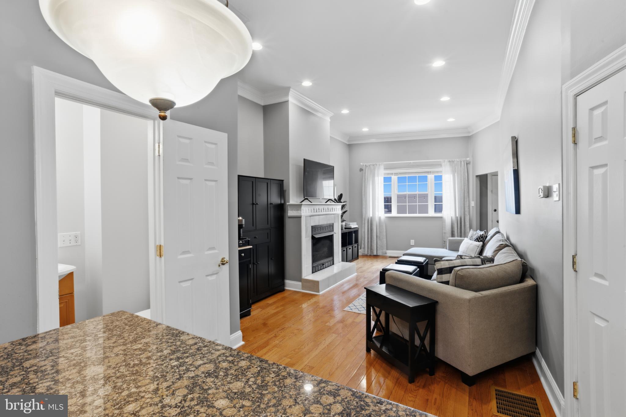 902 South 8th Street Philadelphia, PA 19147 - Photo 8 of 33 a living room with furniture a refrigerator and a fireplace