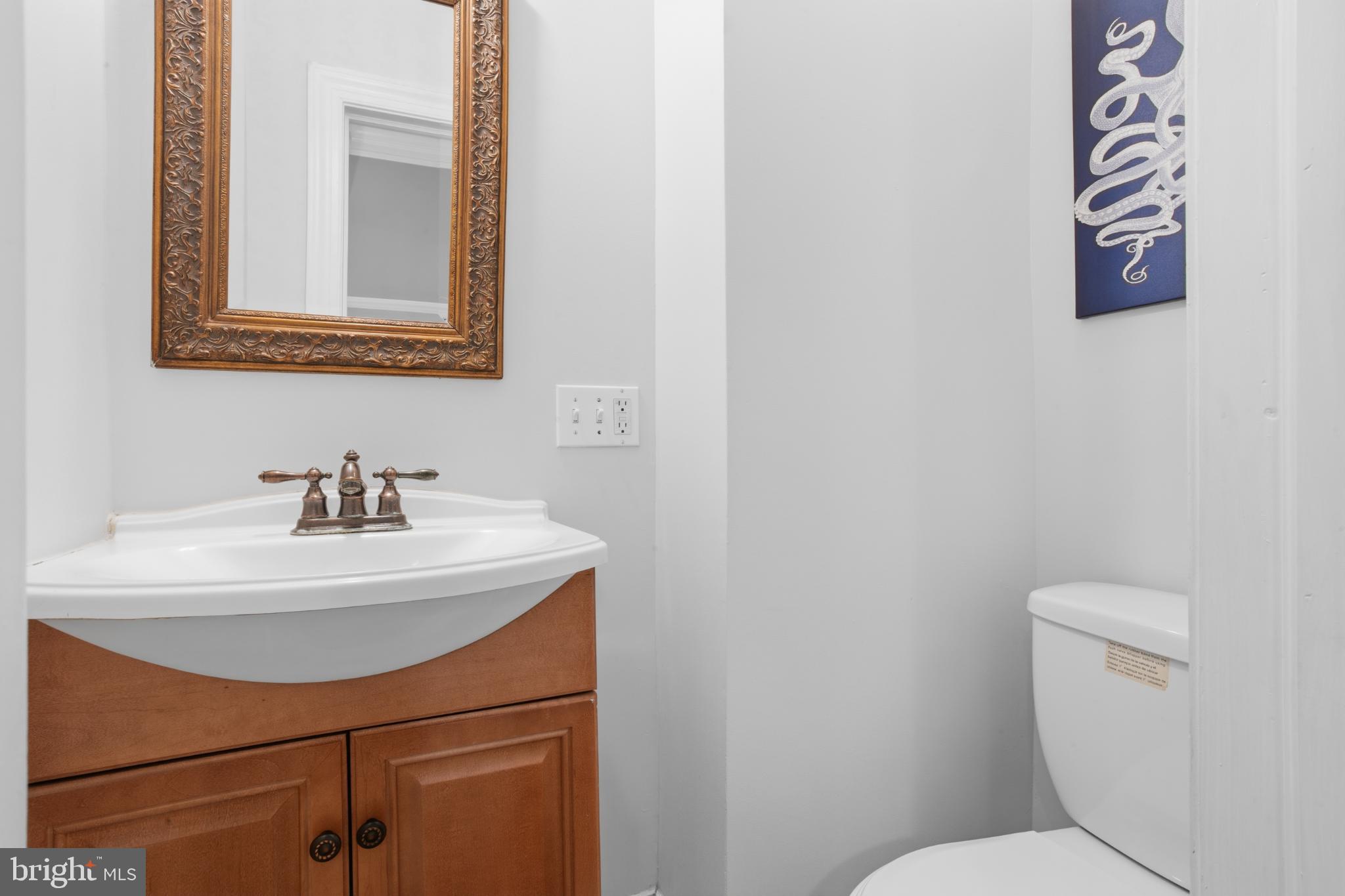 902 South 8th Street Philadelphia, PA 19147 - Photo 9 of 33 a bathroom with a sink a toilet and mirror