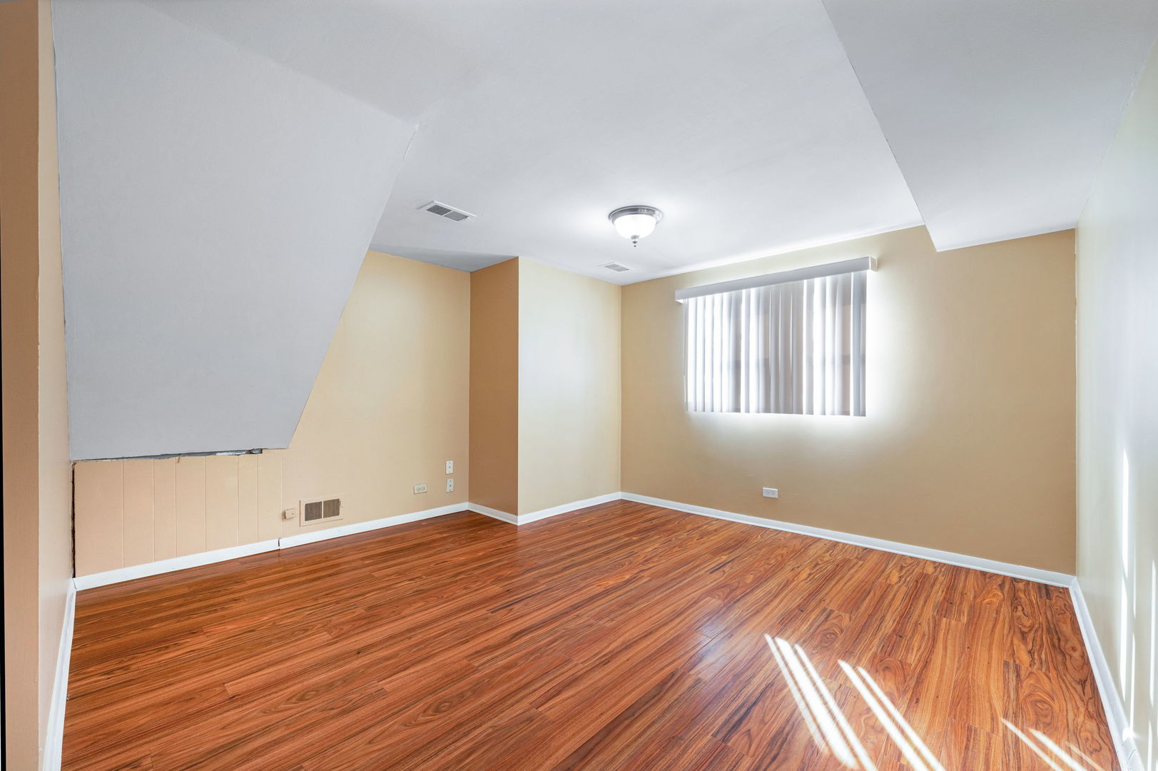 920 Valley Stream Drive Wheeling, IL 60090 - Photo 15 of 29 a view of an empty room with wooden floor and a window