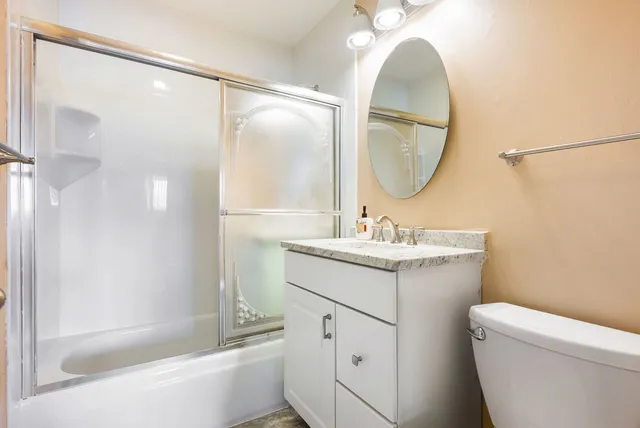 a bathroom with a sink toilet and a mirror