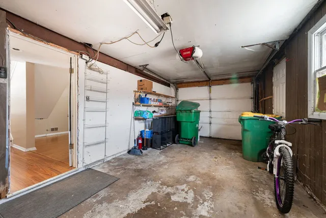 a view of a garage with storage and utility