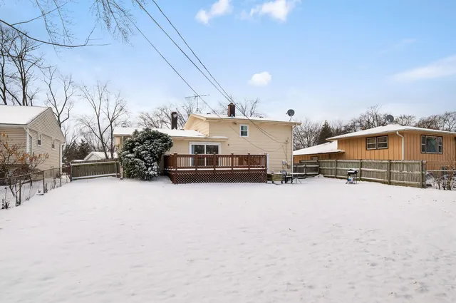 a view of a house with a snow in the yard