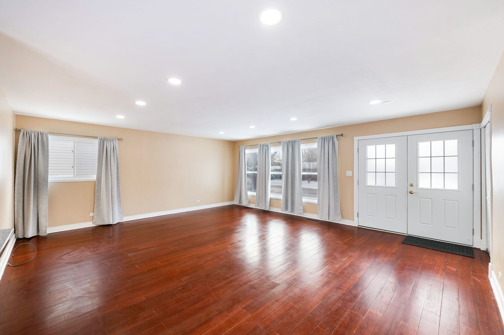 920 Valley Stream Drive Wheeling, IL 60090 - Photo 4 of 29 a view of an empty room with wooden floor and a window