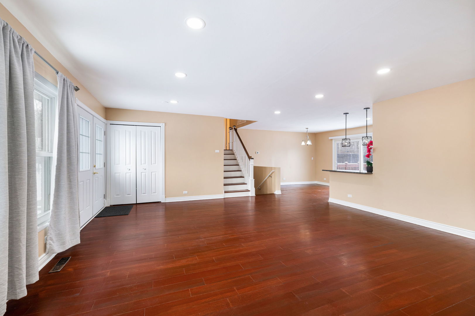 920 Valley Stream Drive Wheeling, IL 60090 - Photo 5 of 29 a view of an empty room with wooden floor and stairs