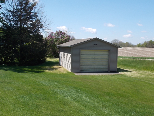 201 Maple Street Cedar Point, IL 61316 - Photo 11 of 12 a front view of a house with a yard and garage