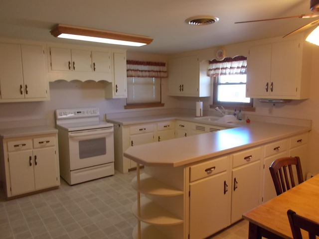 201 Maple Street Cedar Point, IL 61316 - Photo 5 of 12 a kitchen that has a sink a stove and window