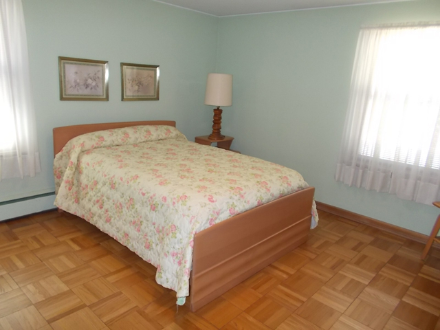 201 Maple Street Cedar Point, IL 61316 - Photo 6 of 12 a bed sitting in a bedroom next to a window