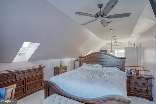a large bedroom with a bed and a chandelier