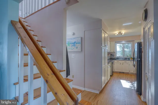 a view of an entryway with wooden floor and a livingroom