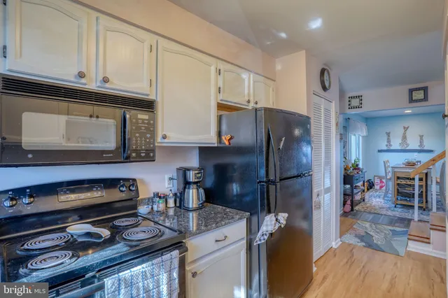 a kitchen with stainless steel appliances granite countertop a refrigerator stove and microwave
