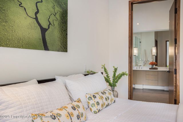 a bedroom with a bed and a potted plant