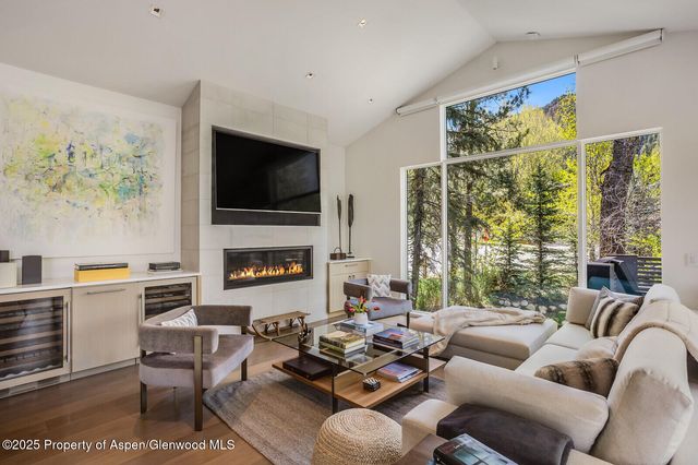 a living room with furniture fireplace and a flat screen tv