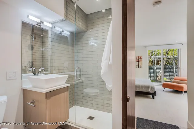 a en suite bathroom with a sink shower and a mirror