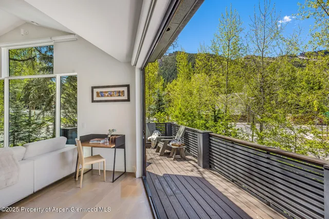 a front view of a house with a garden and garage