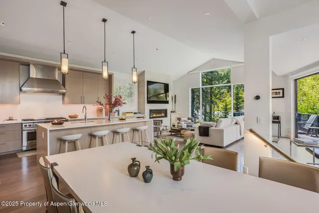 a view of kitchen with stainless steel appliances a dining table and chairs