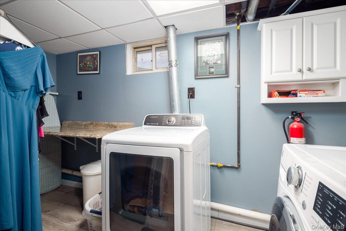 11 Adelphi Road Hicksville, NY 11801 - Photo 18 of 26 a utility room with dryer and washer