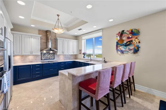 a bathroom with a granite countertop sink and a bathtub