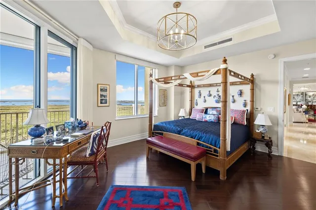 a bedroom with a bed and a chandelier