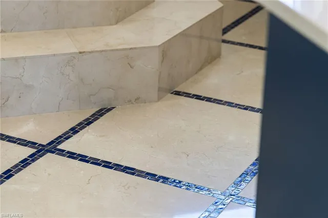 a spacious bathroom with a tub sink and mirror