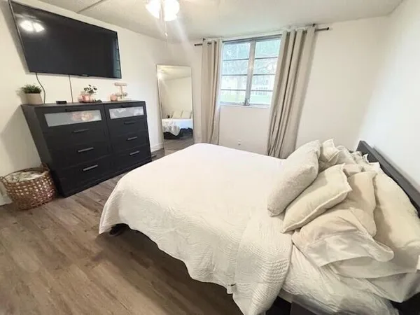 a bedroom with a bed and a flat screen tv