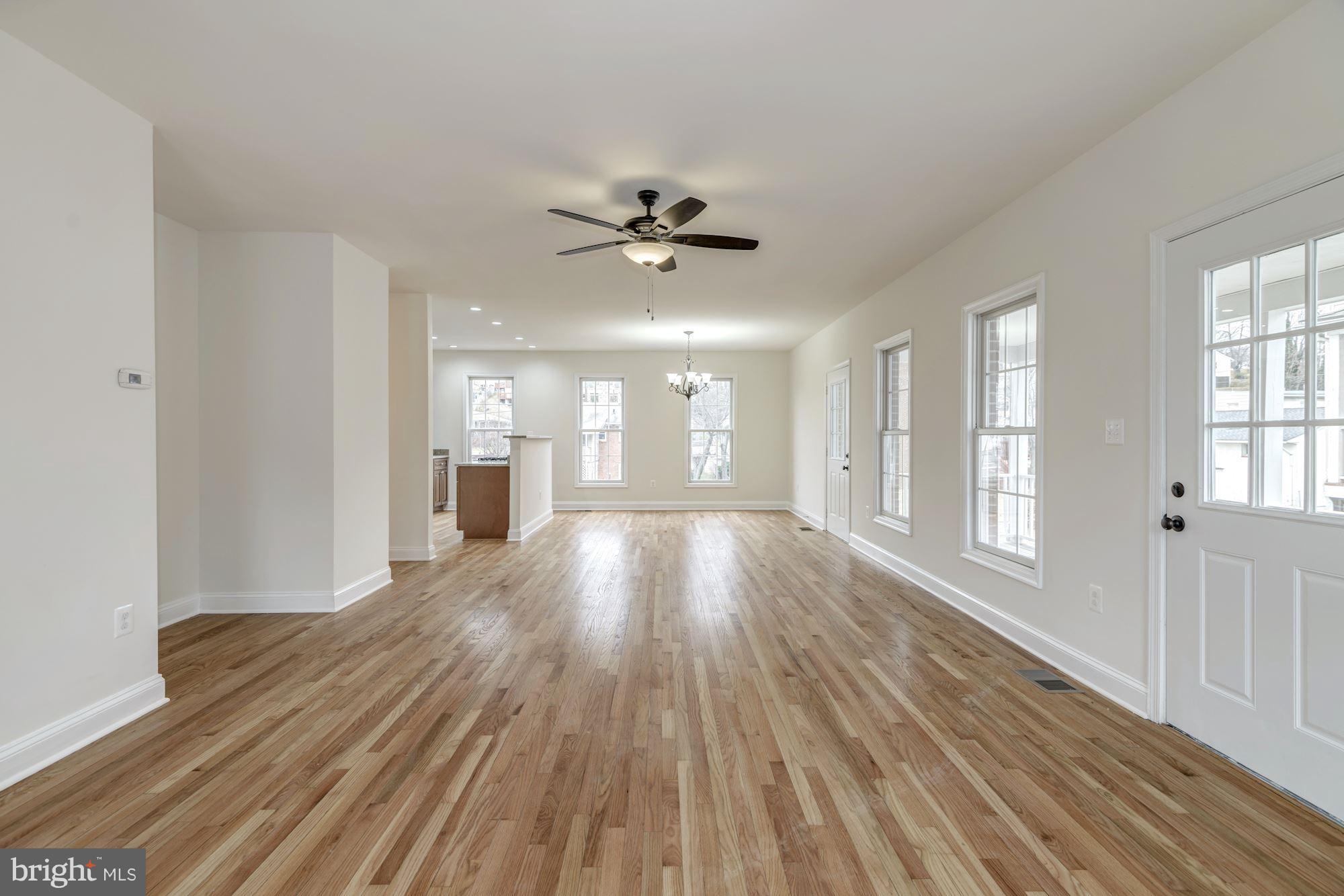 2016 South Glebe Road Arlington, VA 22204 - Photo 4 of 27 a view of an empty room with a window and wooden floor
